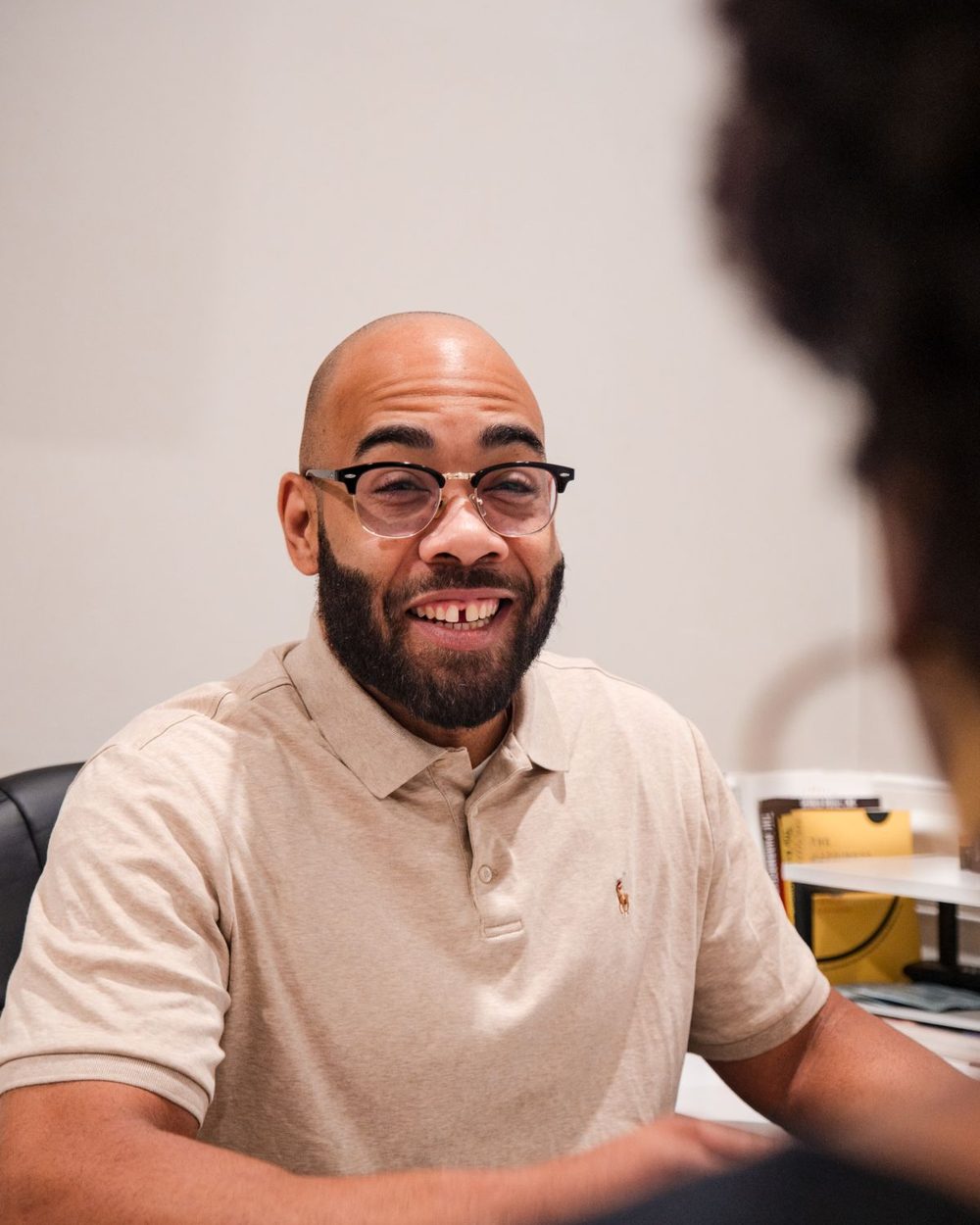 Eric Paige smiling across the desk during a client consultation