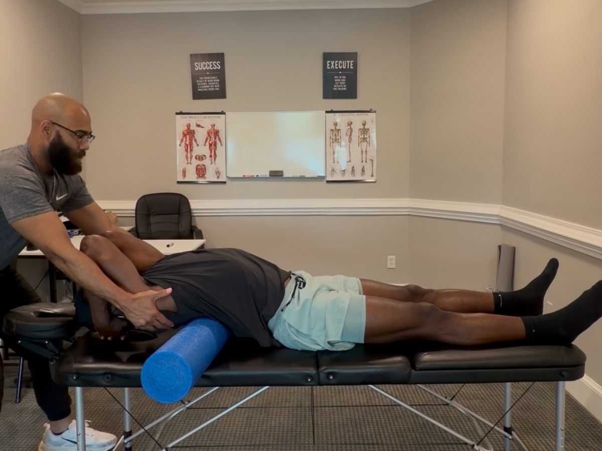 Foam roller and hands-on soft tissue work during an SMR education session